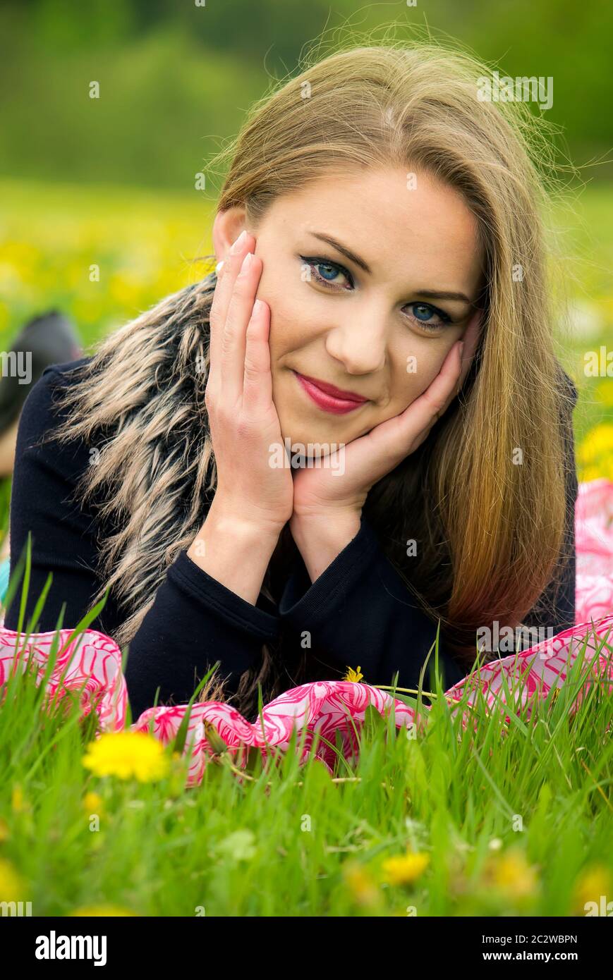 Pretty young girl relaxing in the green grass Stock Photo - Alamy