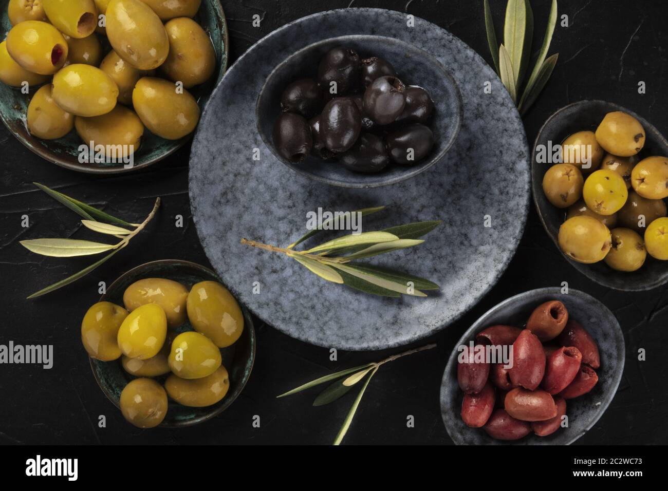 Olives variety, a flat lay. Black, green and red olives, shot from the top on a dark background Stock Photo