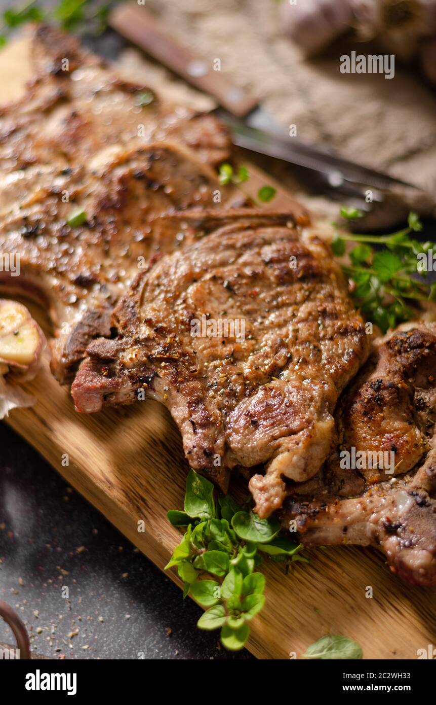 Delicious grilled meat seasoned with garlic and pepper, fresh salad