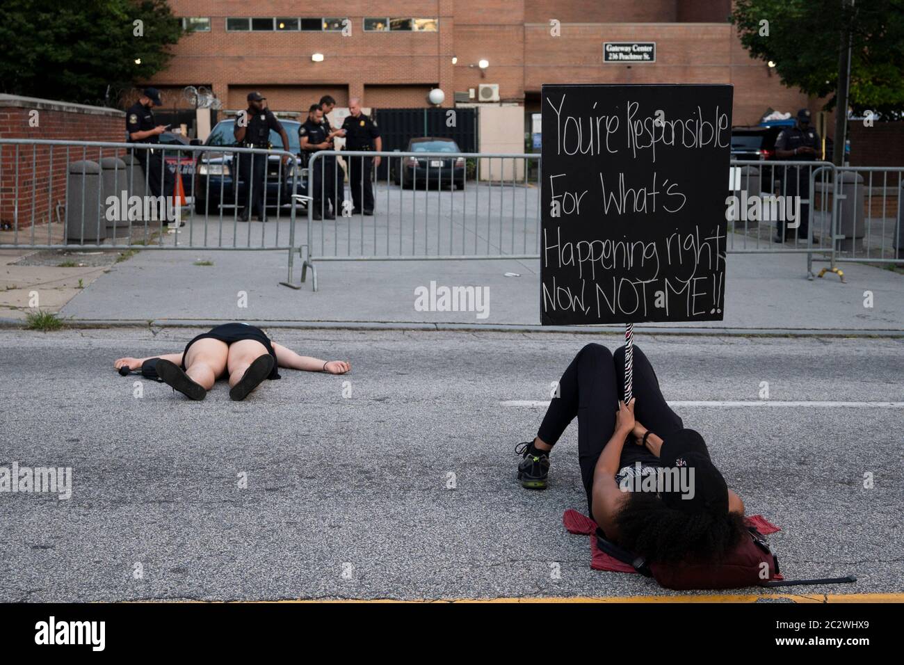 Atlanta, USA. 17th Jun, 2020. Protester holds a sign for police to see, outside of police headquarters in Atlanta, USA, during the Die-In protest for black lives. Credit: Micah Casella/Alamy Live News. Stock Photo