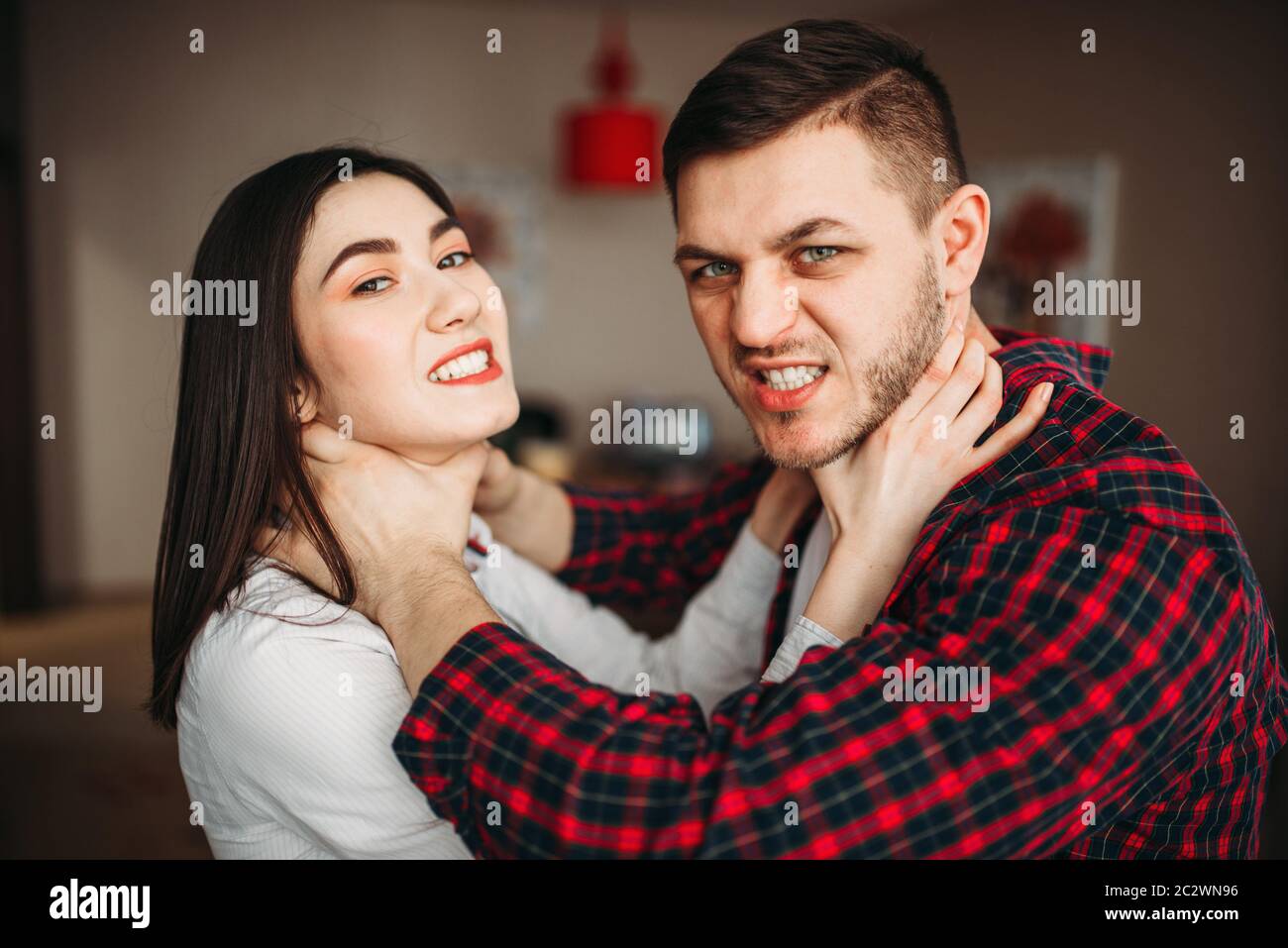 Husband and wife yelling at each other, family quarrel. Man and woman in abuse, couple fighting Stock Photo