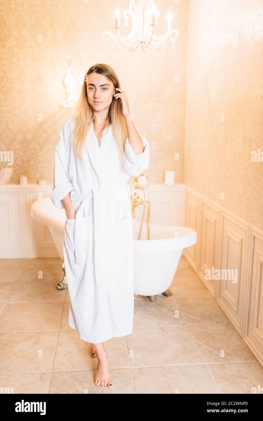 Beautiful woman in white bathtube, bathroom on background. Bodycare and hygiene, healthcare Stock Photo
