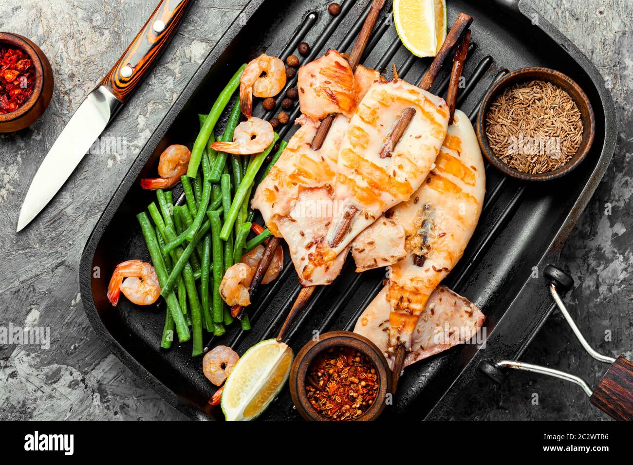Grilled squid on a skewer with a vegetables.Barbecue squids on grill