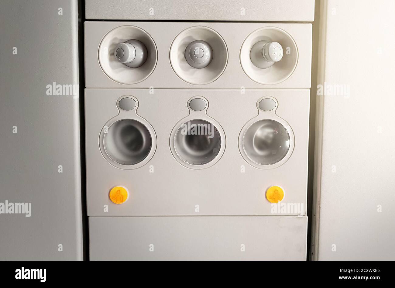 Adjustable lights and air conditioners overhead seat controls of a commercial aircraft in an airplan Stock Photo