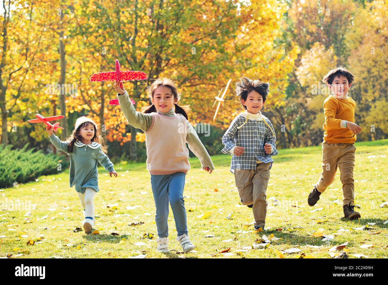 With a model plane happy children playing in the park Stock Photo - Alamy