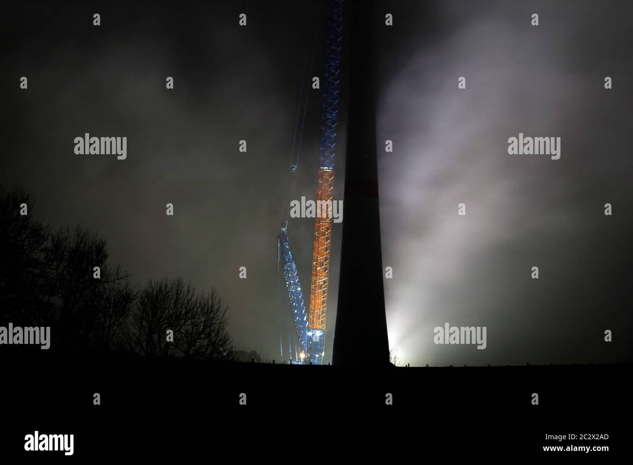 wind turbine assembly, illuminated in the night Stock Photo