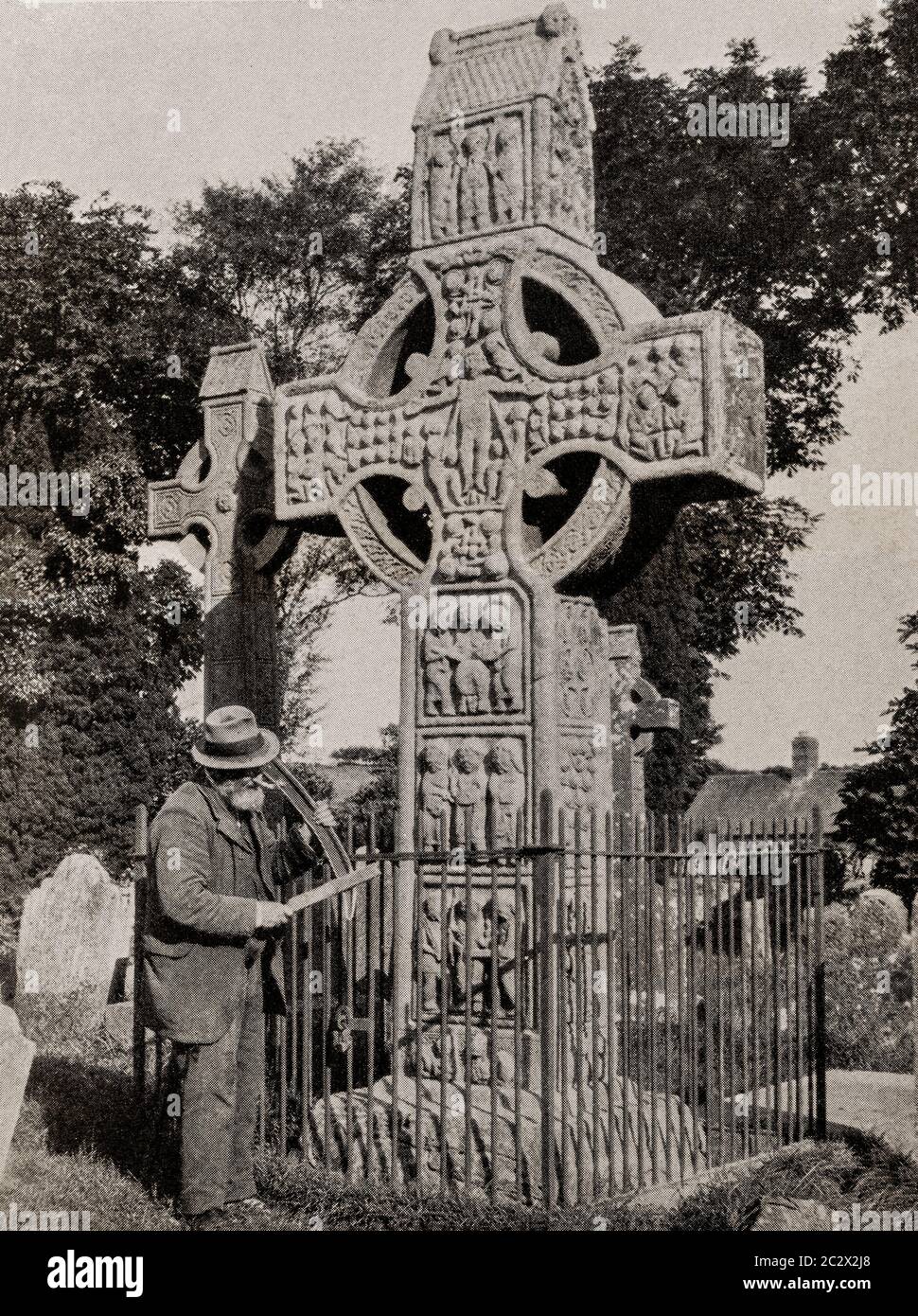 An early 1920's view of the 9th century, stone,  high cross in Monasterboice Monastery in County Louth, Ireland. Originally photographed by Clifton Adams (1890-1934) for 'Ireland: The Rock Whence I Was Hewn', a National Geographic Magazine feature from March 1927. Stock Photo
