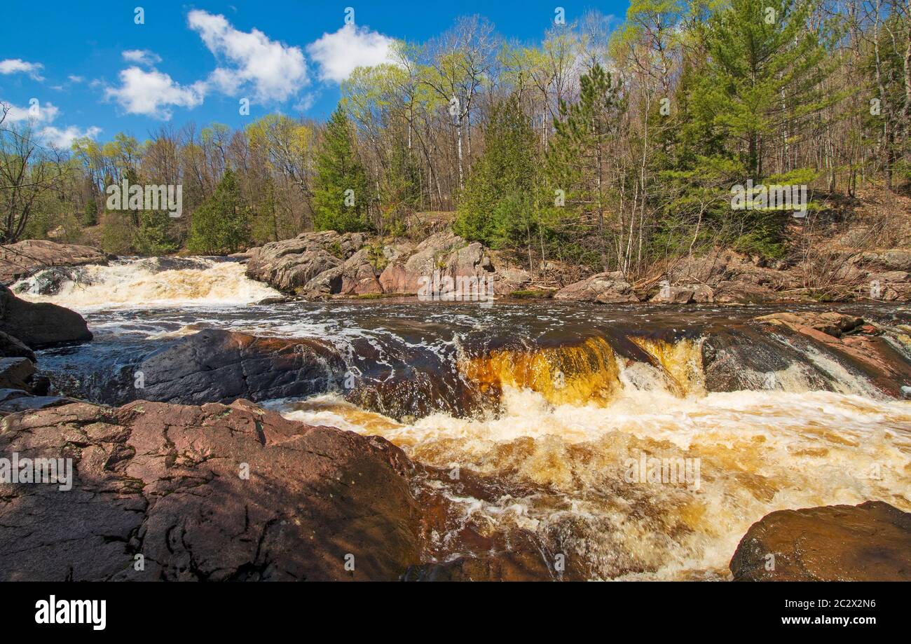 Brown Water flowing over the Red Granite Falls on the Bad River in