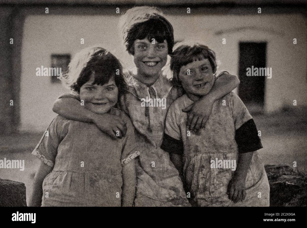 An early 1920's view of three young girls, from Drogheda on the Louth/Meath border. Originally photographed by Clifton Adams (1890-1934) for 'Ireland: The Rock Whence I Was Hewn', a National Geographic Magazine feature from March 1927. Stock Photo