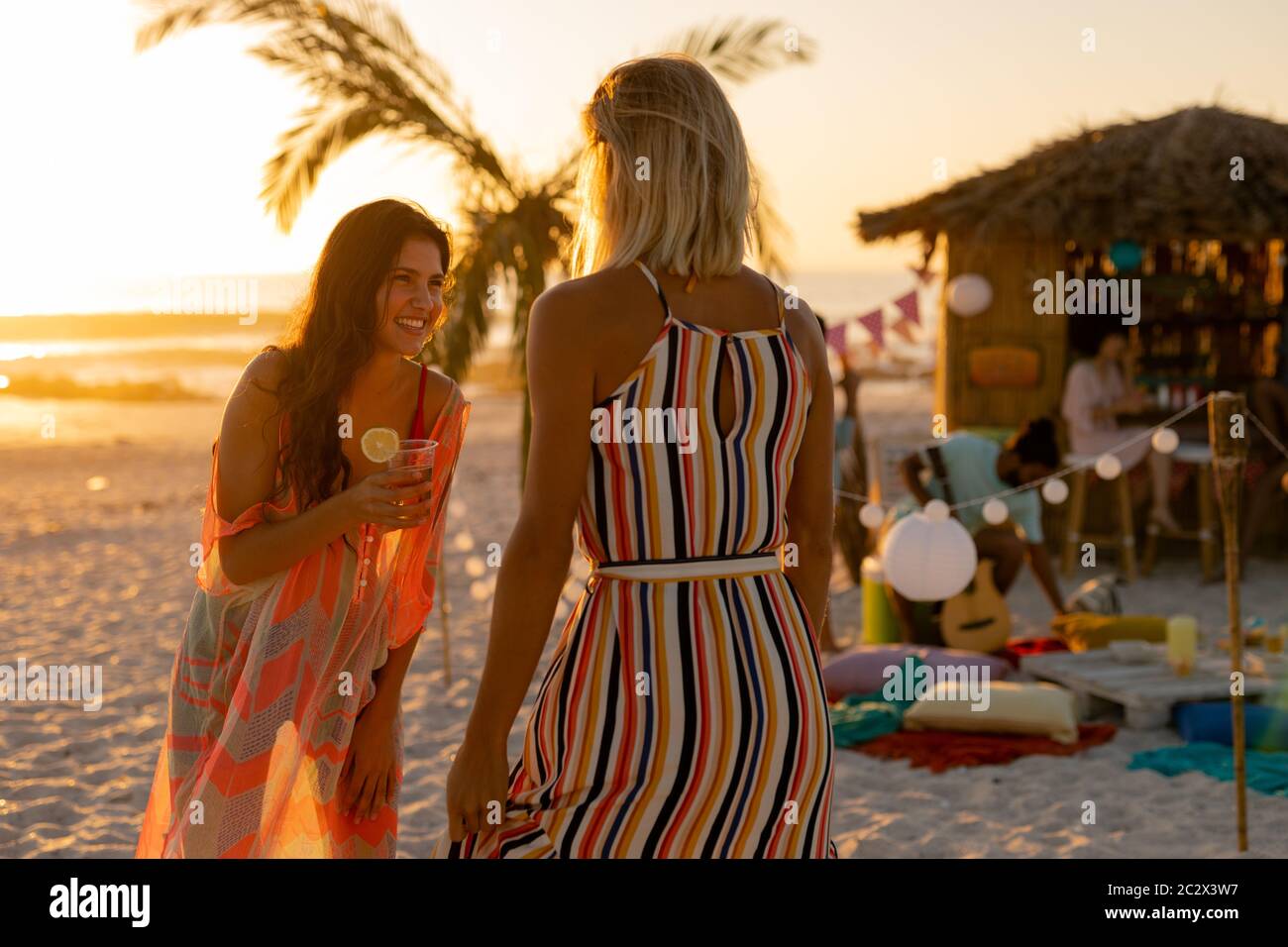 Mixed race friends having fun on beach Stock Photo - Alamy