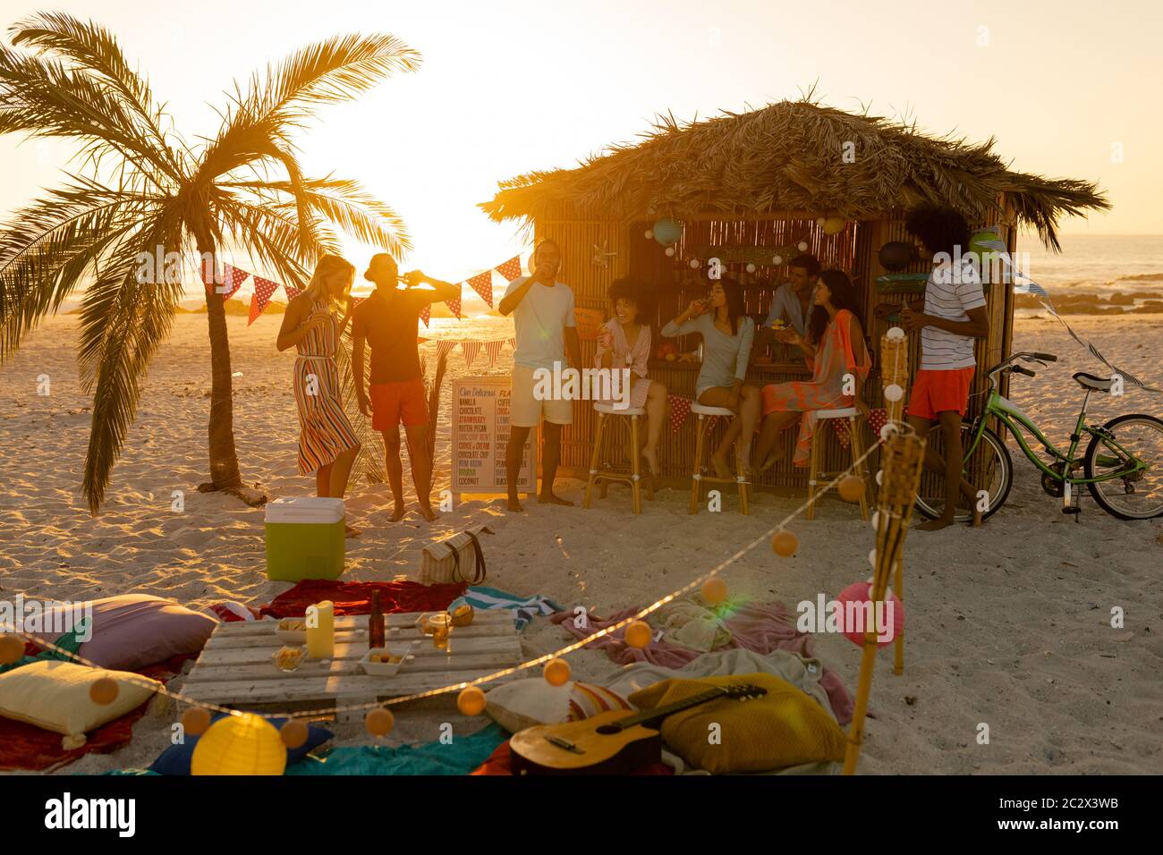 Mixed race friends having fun on beach Stock Photo - Alamy