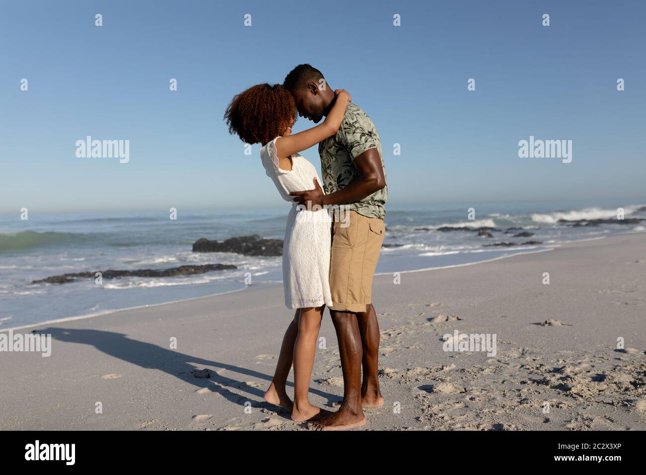 Happy couple embracing each other on the beach Stock Photo