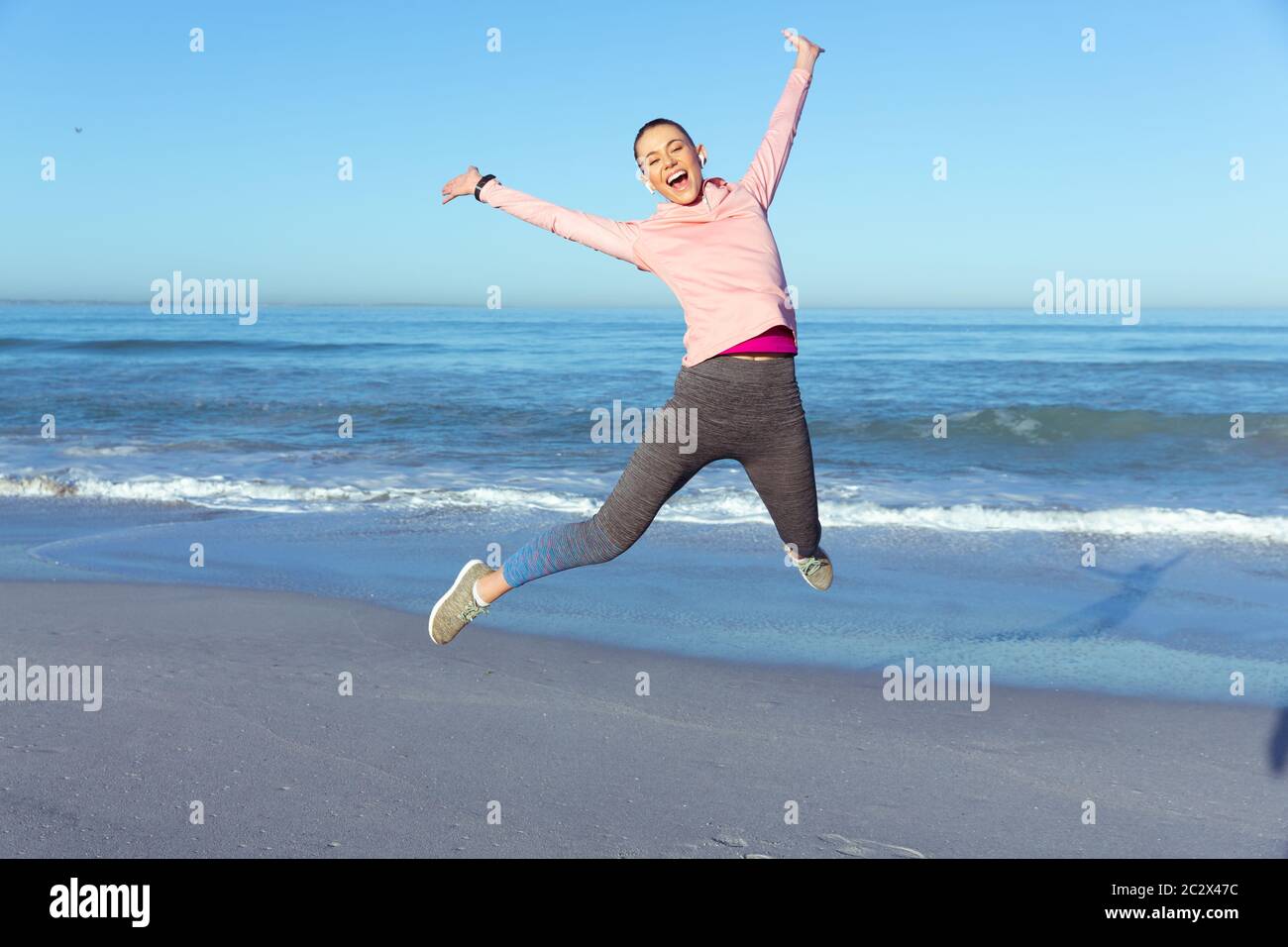 Caucasian woman spending time seaside wearing sportswear Stock Photo