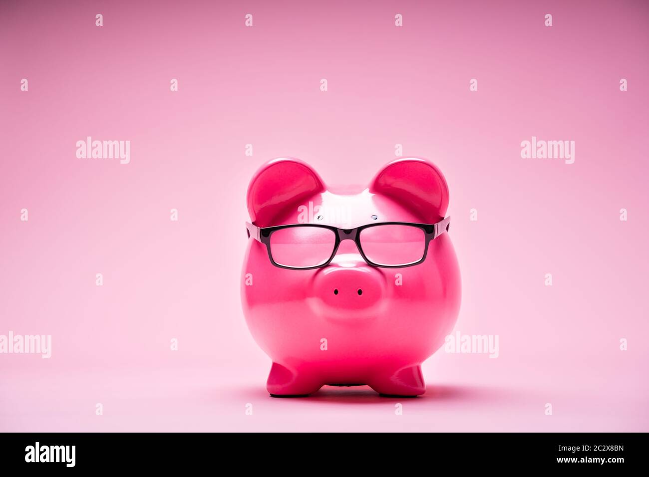 Photo Of Piggybank Wearing Glasses On Pink Background Stock Photo - Alamy