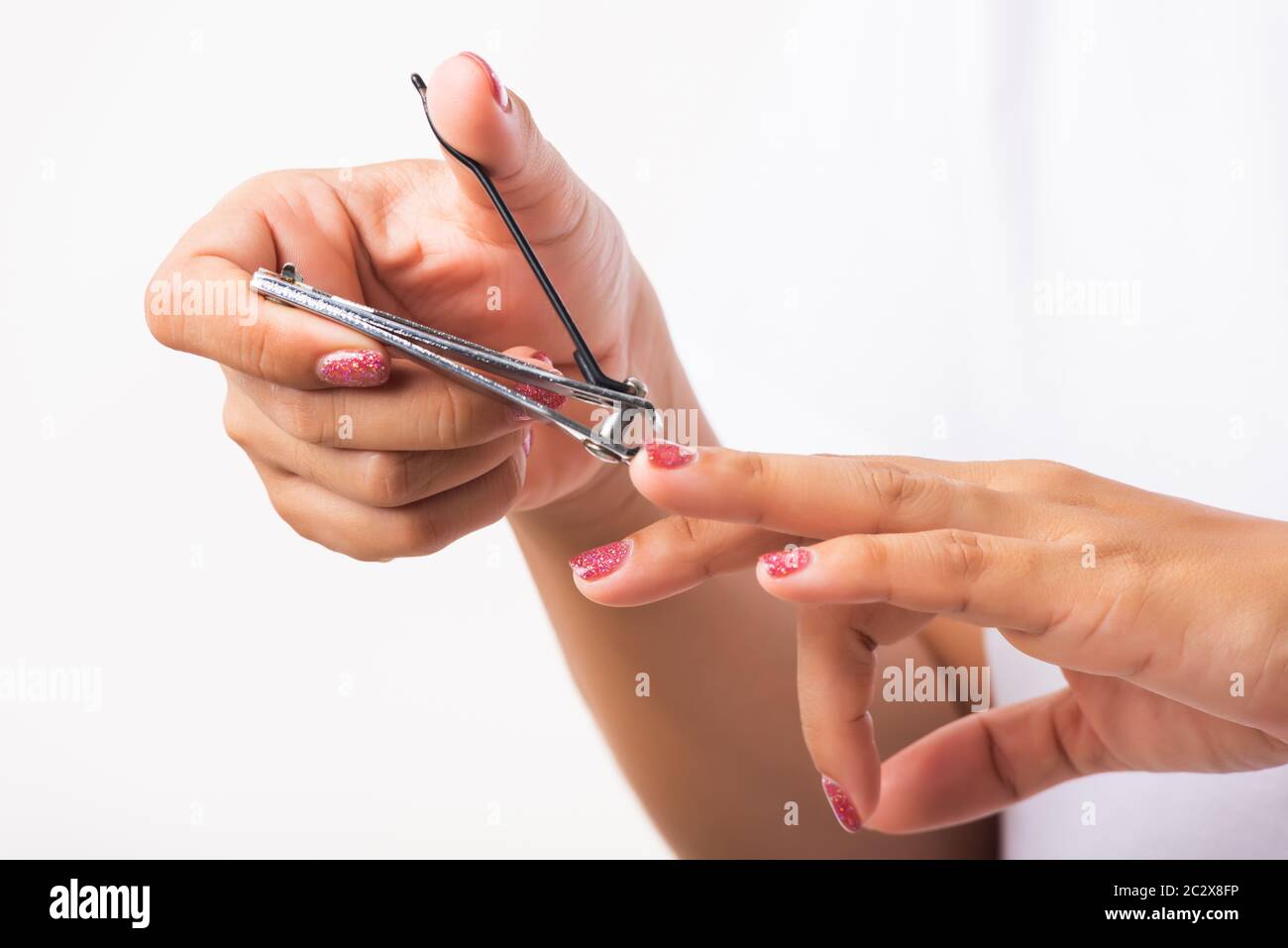 Close up young Asian woman have tool cutting nails fingernails on finger  using a nail clipper. Female using tweezers by herself, studio shot  isolated Stock Photo - Alamy