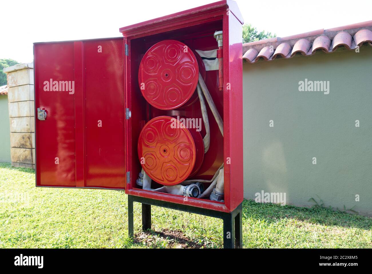 Fire Hose Reel Outdoors. Fire Safety Concept Stock Photo
