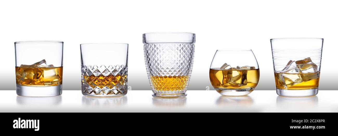 A white bar with a row of different style whisky glasses and ice, isolated  on white with a slight reflection Stock Photo - Alamy