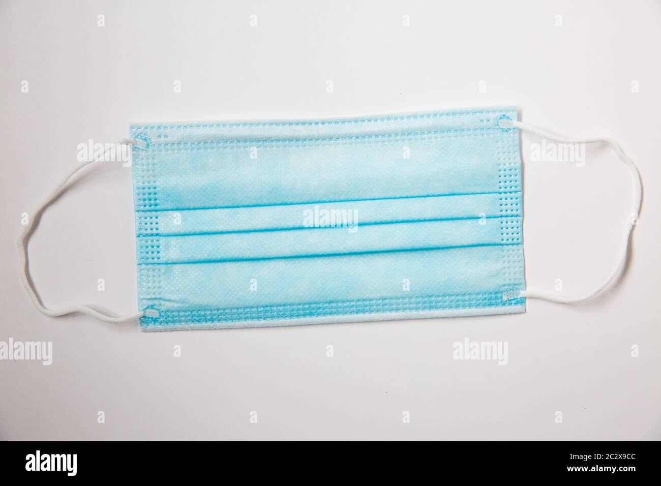 An example of blue surgical face mask used to protect the public from infectious diseases such as Coronavirus. Stock Photo