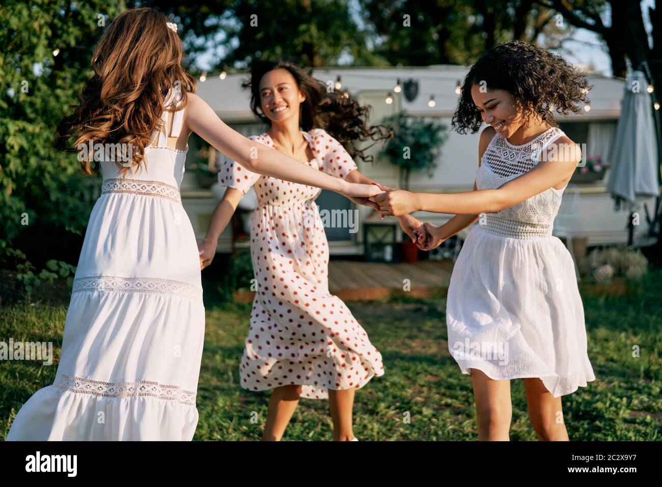 Happy beautiful women dancing in circle during a picnic Stock Photo Alamy