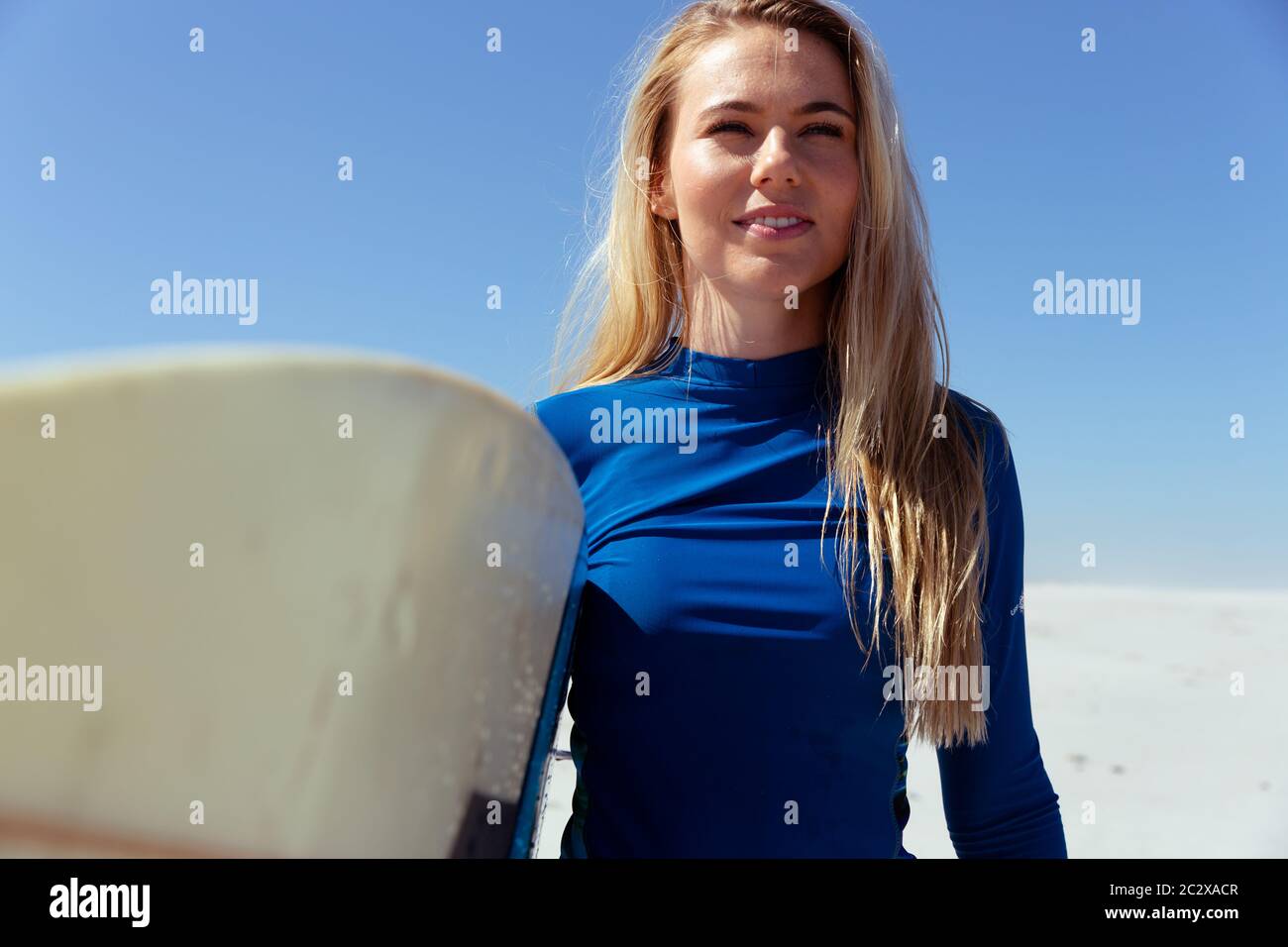 Caucasian woman during surf session at beach Stock Photo