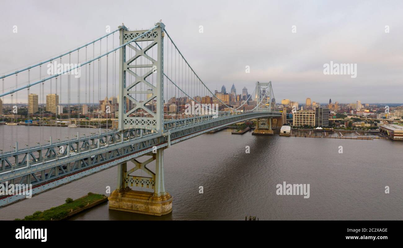 The Ben Franklin Bridge leads travelers into and out of downtown Philadelphia PA over the Delaware River Stock Photo