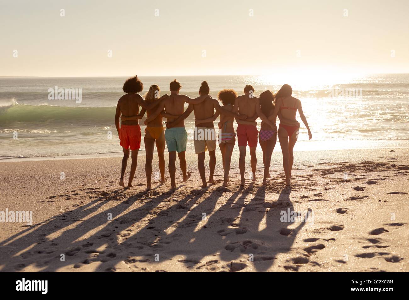 Multi-ethnic group of male and female standing on the beach Stock Photo