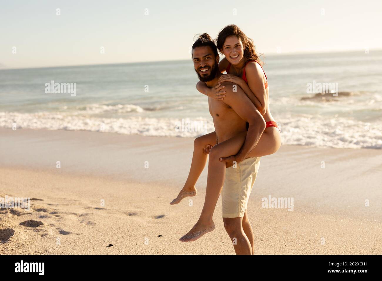 Caucasian couple having fun on the beach Stock Photo