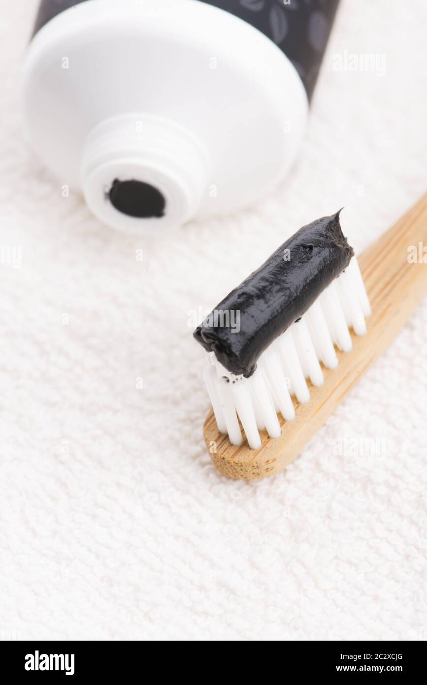 Toothbrush with black charcoal toothpaste Stock Photo - Alamy