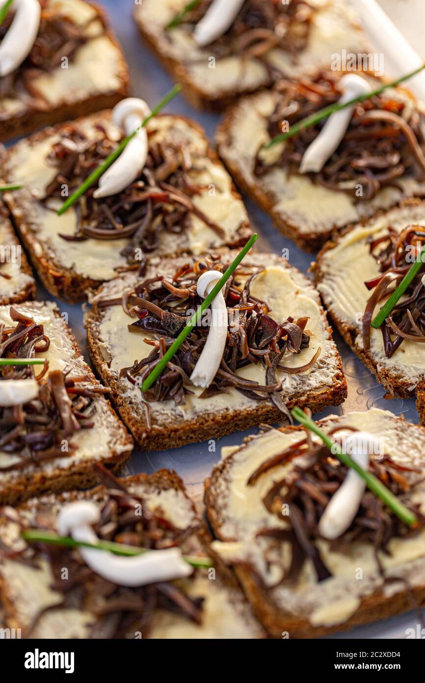 Fresh sliced bread with butter decorated with marinated wood ear edible
