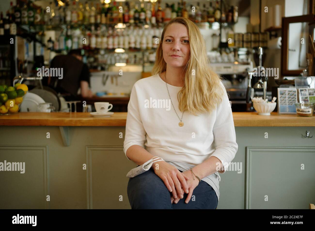 Cologne, Germany. 18th June, 2020. Leah Strube, co-owner of Café Sehnsucht in Cologne Ehrenfeld is sitting in the guest room. (to dpa: 'Slow recovery: How the catering industry is picking itself up') Credit: Henning Kaiser/dpa/Alamy Live News Stock Photo