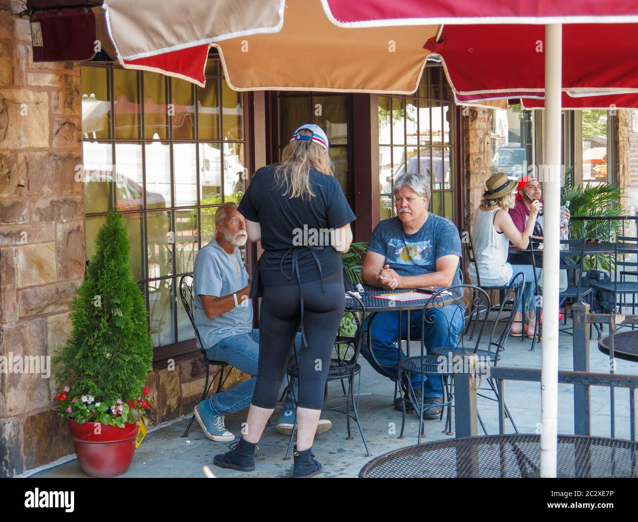 Oak Park, Illinois, USA. 17th June 2020. A waiter serves patrons at a