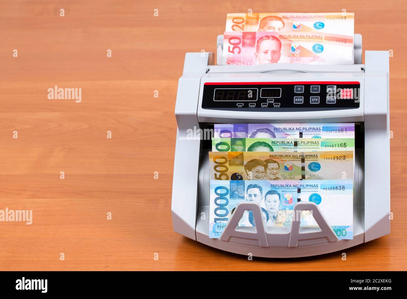Money from the Philippines in a counting machine Stock Photo