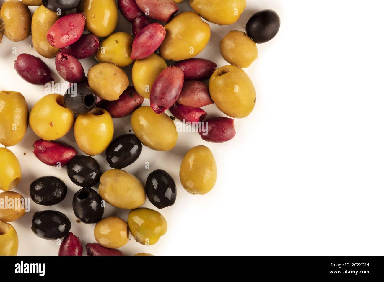 Olives variety. Black, green and brown olives, an assortment, shot from the top on a white background with a place for text Stock Photo