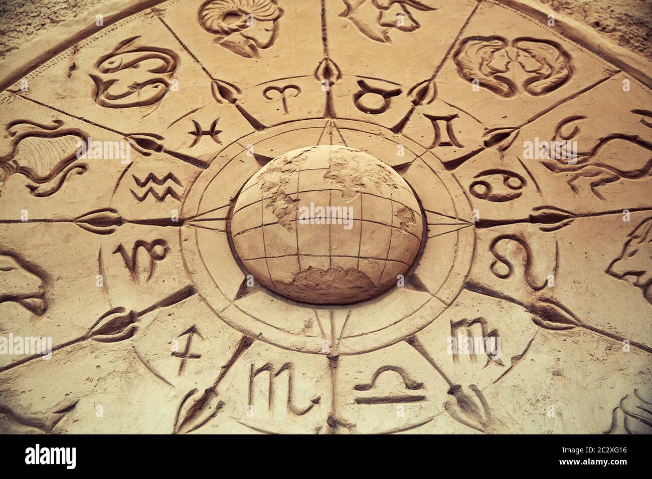 Sand sculpture of globe and zodiac signs Stock Photo Alamy