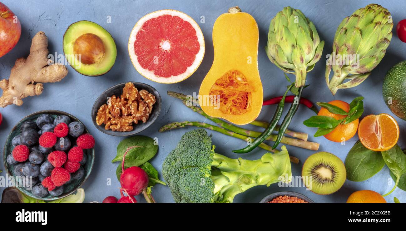 Vegan food panorama. Healthy diet concept. Fruits, vegetables, nuts, shot from above. A flat lay Stock Photo