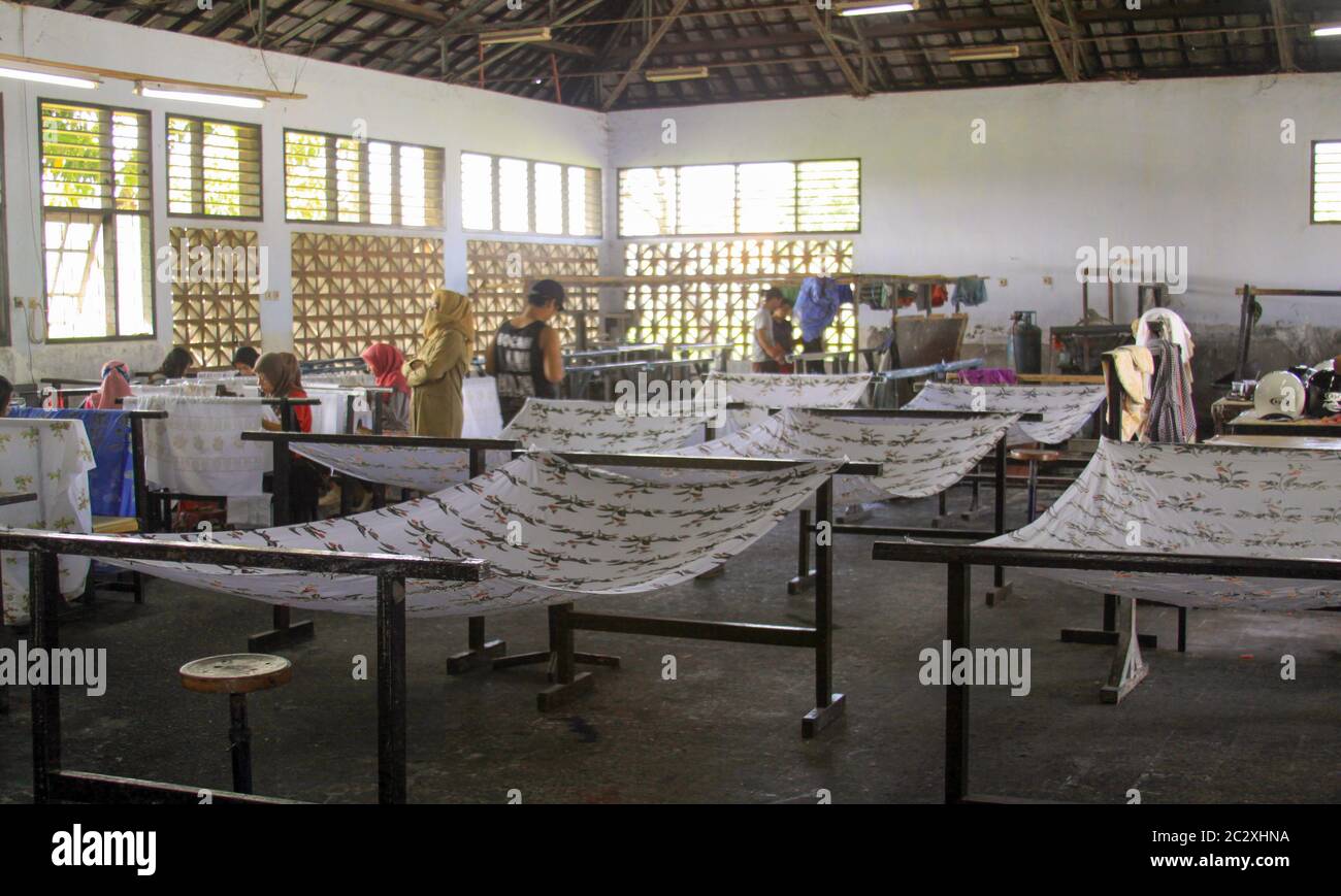 Girls painting in batik school in Mataram Lombok. Teachers supervise girl students in batik