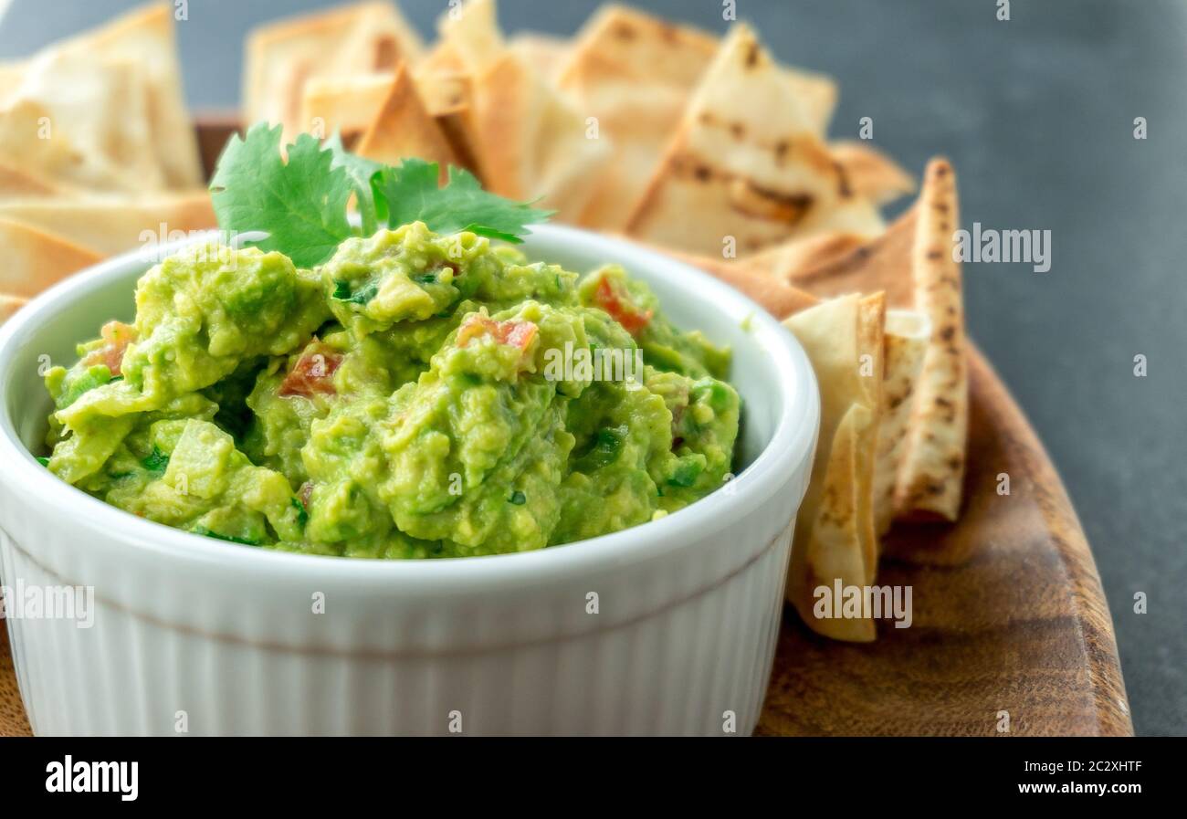 Guacamole close-up view. Guacamole is a avocado based dip, traditionally a mexican (Aztecs) dish. Healthy and easy to make snack at home. Stock Photo