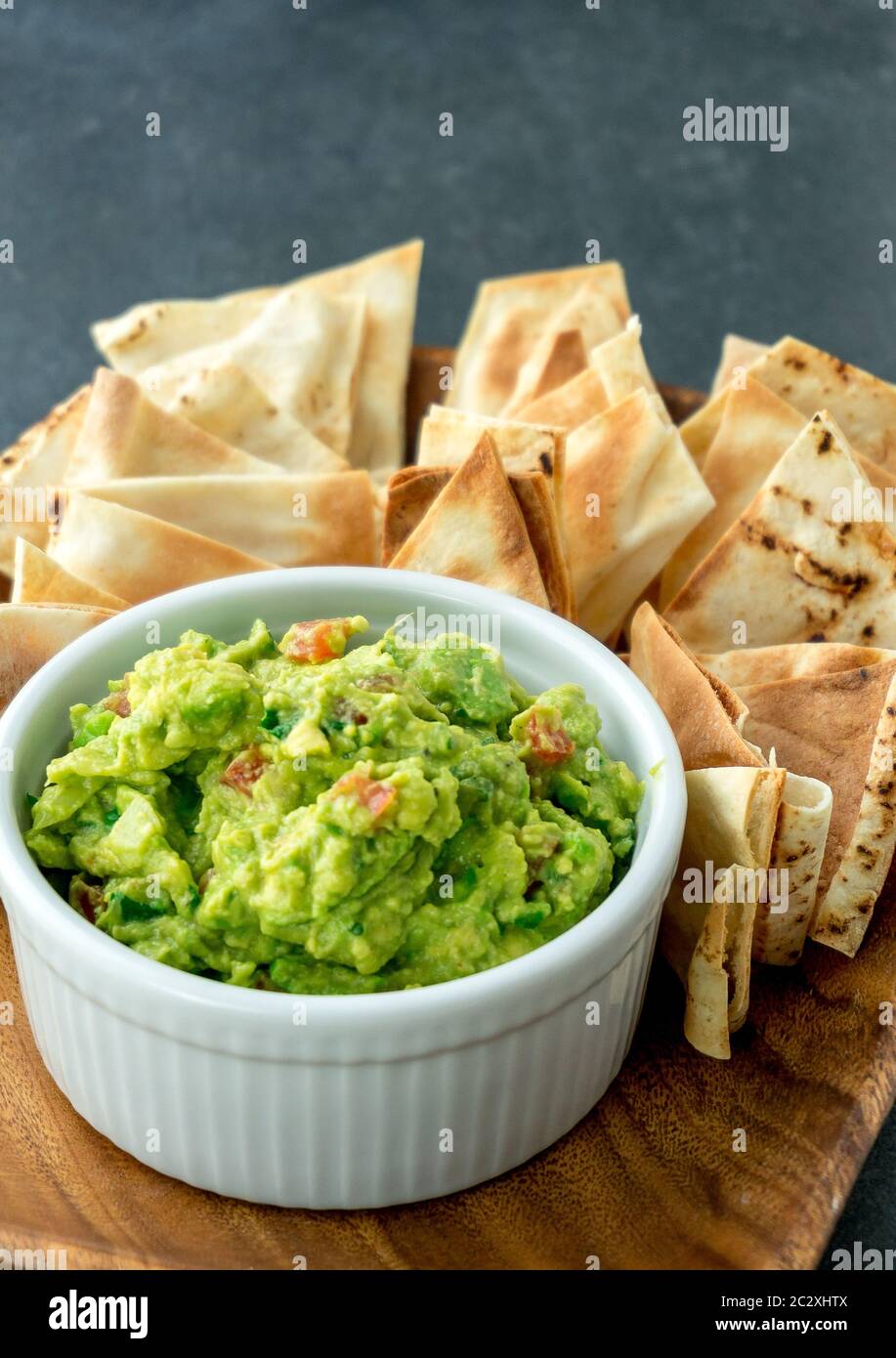 Guacamole vertical view. Guacamole is a avocado based dip, traditionally a mexican (Aztecs) dish. Healthy and easy to make snack at home. Stock Photo