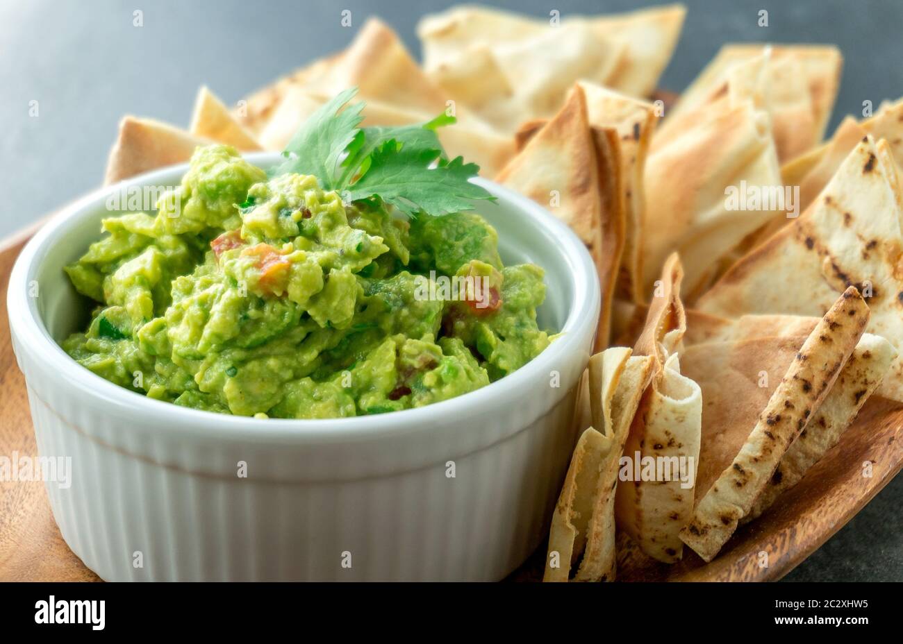 Mexican guacamole dish. Guacamole is a avocado based dip, traditionally a mexican (Aztecs) dish. Healthy and easy to make snack at home. Stock Photo