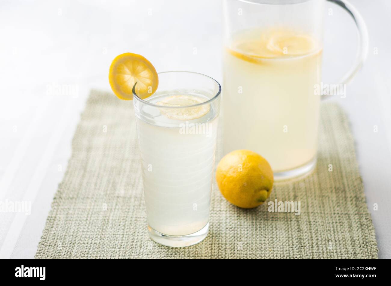 Lemonade glass and pitcher. Lemonade is traditionally a homemade drink