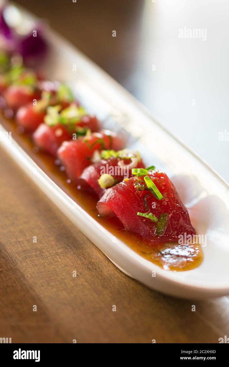 Tuna sashimi is a delicious japanese cuisine dish consisting of thinly sliced fresh raw fish, in japan it is often served as appetizer in restaurants. Stock Photo