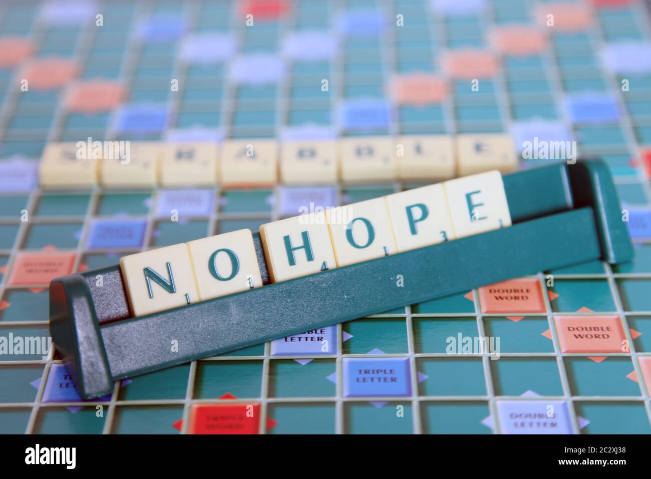 Scrabble letters tiles in rack spelling No Hope Stock Photo Alamy