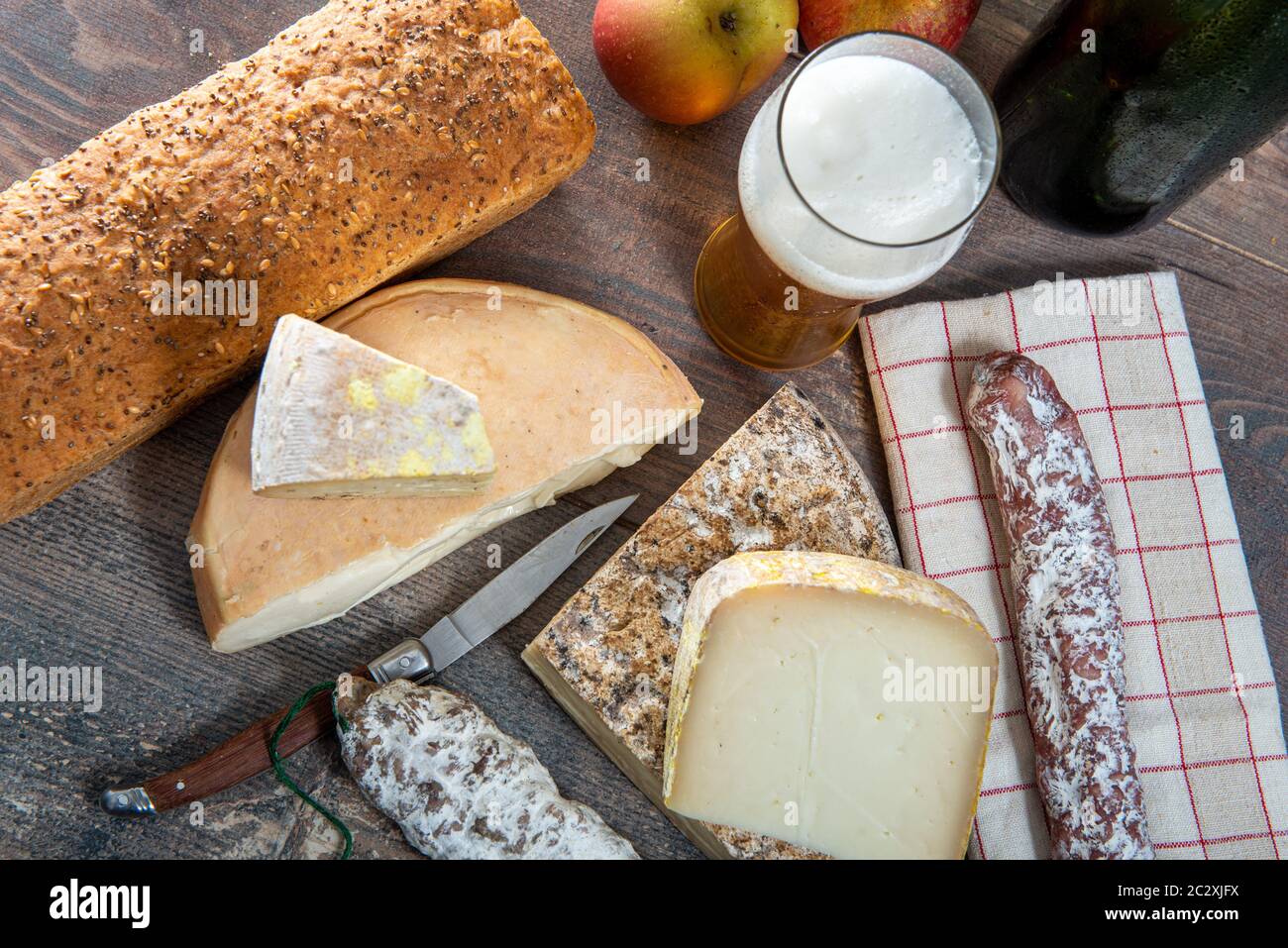 cheeses and Tomme de Savoie with beer, French cheese Savoy, the french Alps France. Stock Photo