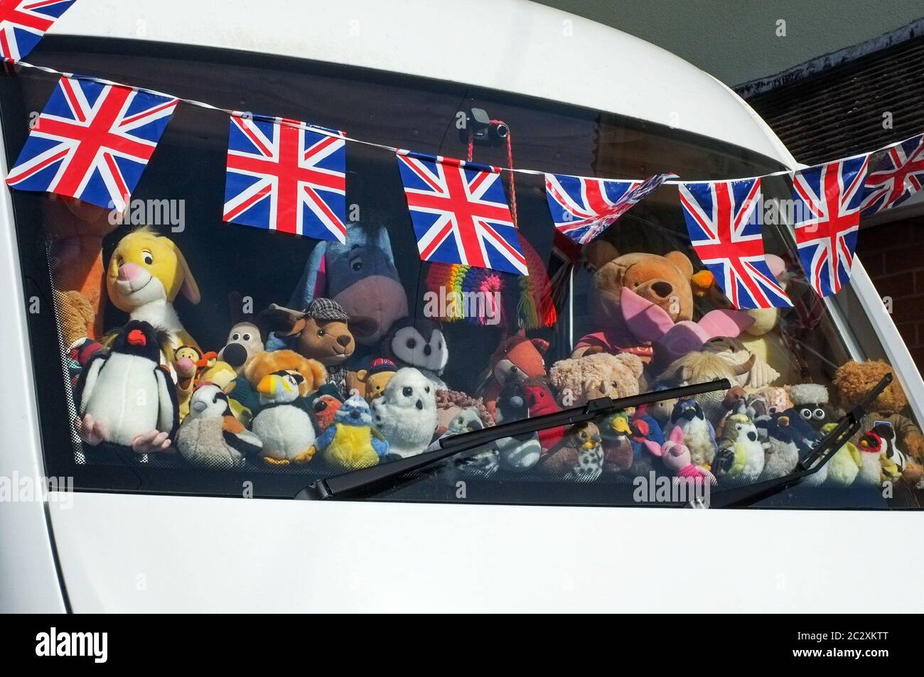 Proudly displaying the UK Union Flag - A camper van dashboard covered with stuffed toys during the VE day 75th celebrations in May 2020. Wilton Wiltshire UK. Stock Photo