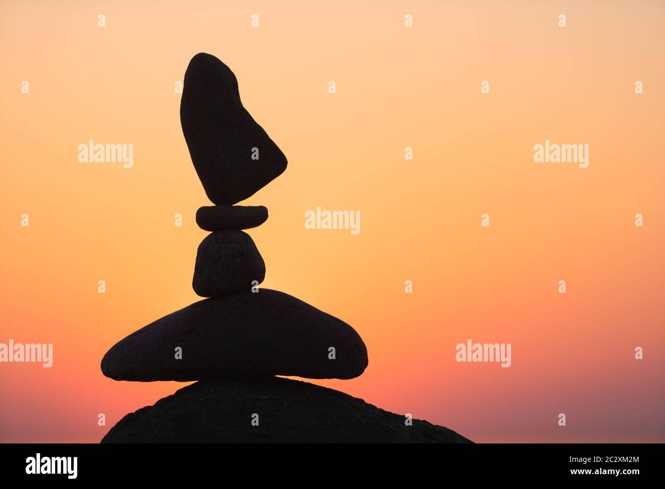 balanced stones on the beach at sunset Stock Photo - Alamy