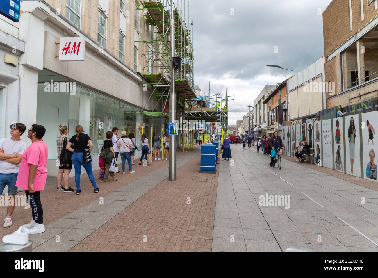 Southend-on-Sea, UK. 18th June, 2020. Shoppers queue outside H&M. Social  distancing measures on the High Street in Southend-on-Sea. The Council has  tried to introduce a one way system for the pedestrianised area