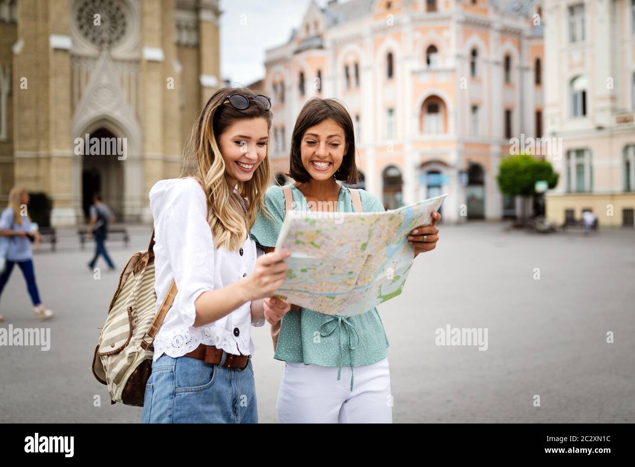 Happy travel together of two beautiful women in city centre Stock Photo