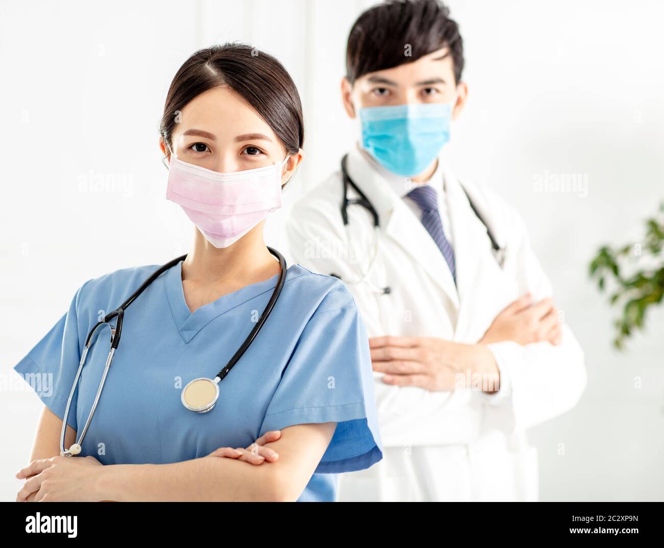 two doctors faces wearing protective mask Stock Photo