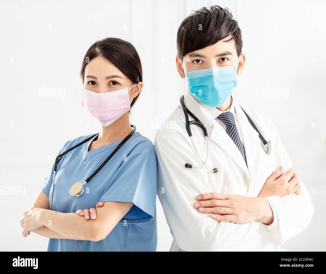 two doctors faces wearing protective mask Stock Photo