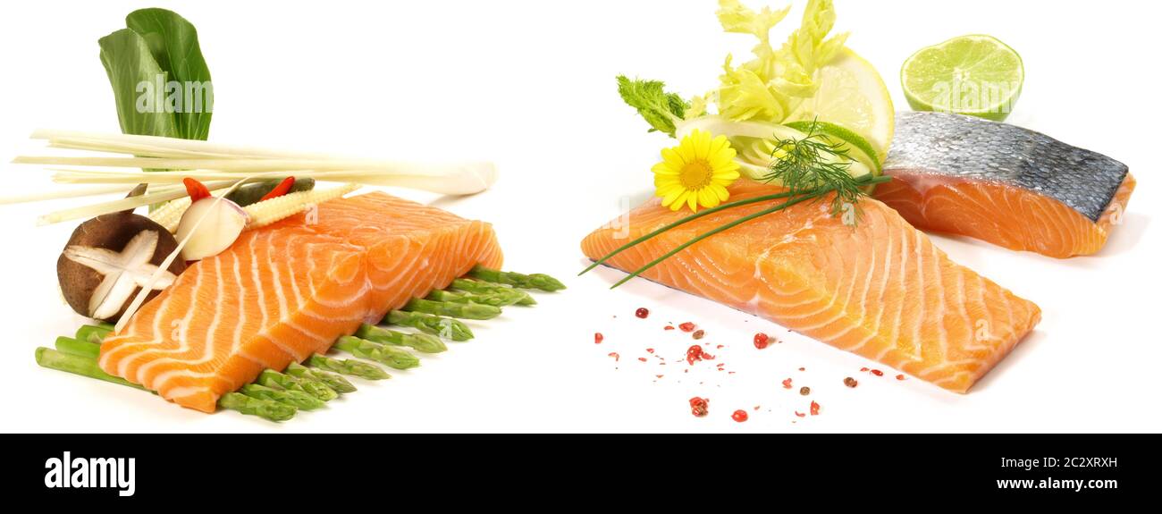 Various Salmon Steaks - Raw Fish Fillet with green Asparagus, Salad and Vegetables isolated on white Background Stock Photo